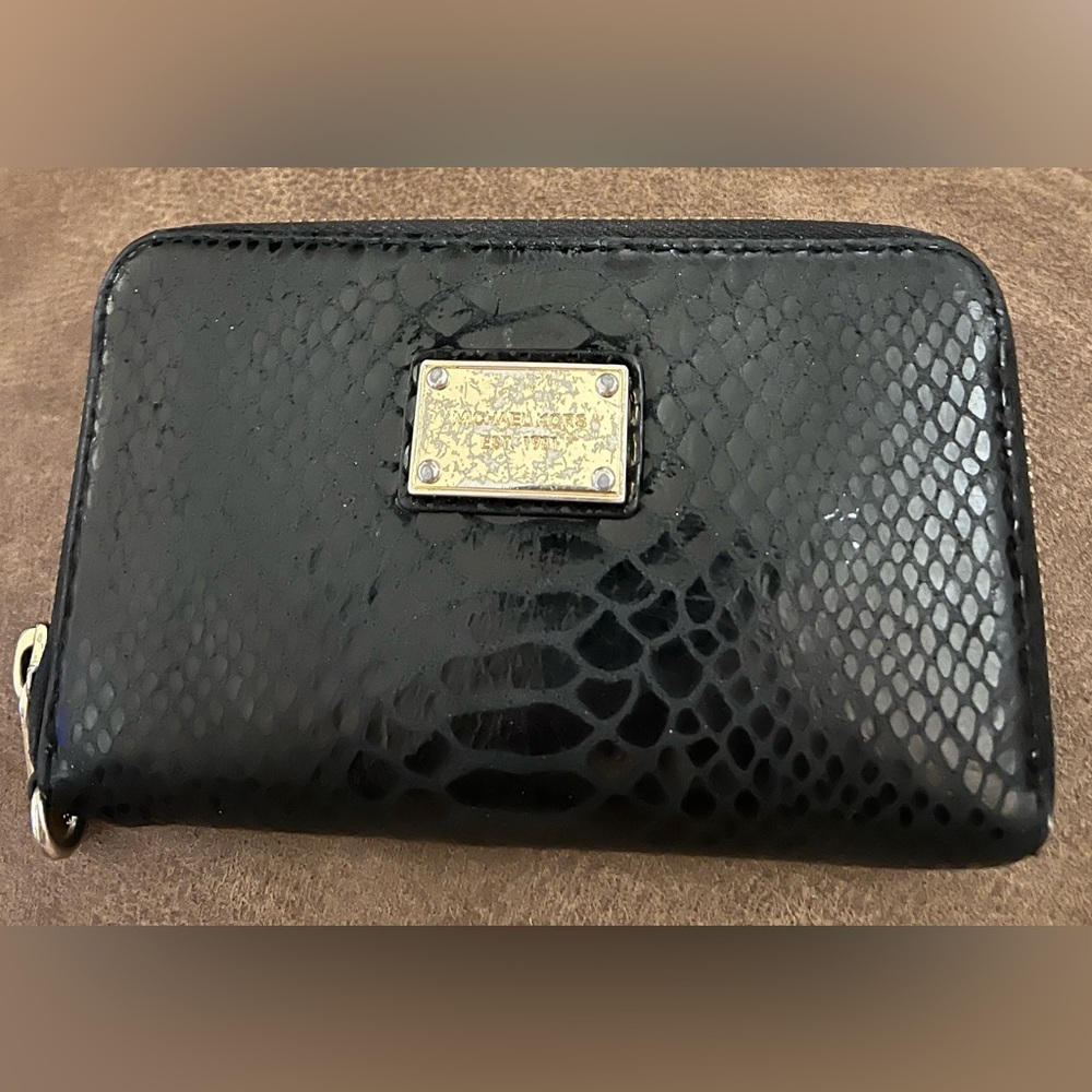 Michael Kors black card holder zip around animal print wallet.